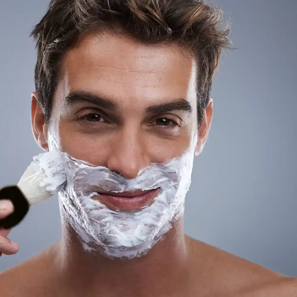 Man applying shaving cream.