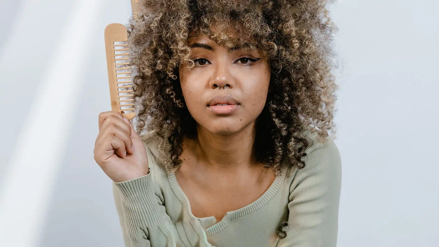 Woman holding a hair comb.